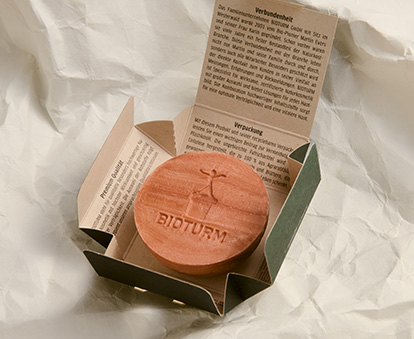 Ansicht einer aufgefalteten Verpackung eines Feststücks.